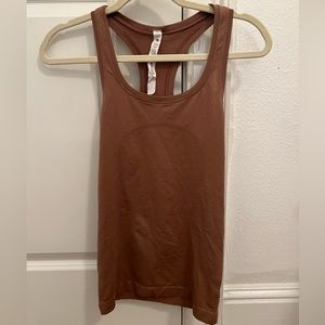 lululemon swiftly tank in a light brown color, the tank top is lighter in person